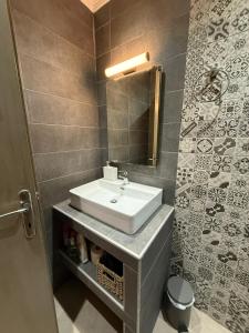 a bathroom with a sink and a mirror at Ethereal studio in Afytos in Afitos