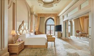 a bedroom with a large bed and a desk at Emirates Palace Mandarin Oriental, Abu Dhabi in Abu Dhabi +37 photos