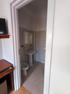 a bathroom with a toilet and a sink at Anthos Residence sul mare in Cariati +17 photos
