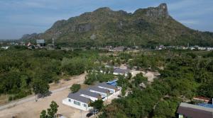 an aerial view of a building with a mountain in the background at Wana Villa ChaAM in Cha Am