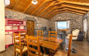 a kitchen and dining room with a wooden table and chairs at Casa Antica - Storia Verde Opatija in Veprinac
