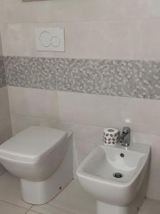 aseo blanco y lavabo en el baño en Fabiola home, en Borgo Montenero