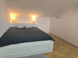 a bedroom with a bed with two pillows on it at Buda-city house in Trnávka