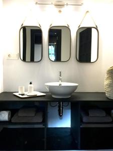 a bathroom with a sink and four mirrors at Villa Margarita in Palma de Mallorca +11 photos