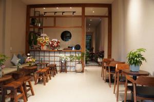 a dining room with wooden tables and chairs at Thom Homestay in Da Lat