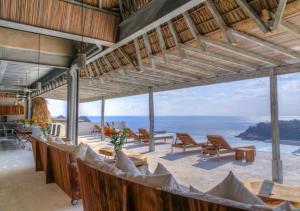 a restaurant with a view of the ocean at Casa Cascada - Adults Only in Puerto Escondido