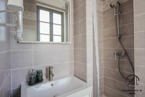 a bathroom with a sink and a shower at Le Nordet Vert in Albi +29 photos