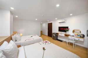 Postel nebo postele na pokoji v ubytování BIG Hotel Sài Gòn