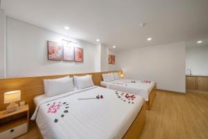 Postel nebo postele na pokoji v ubytování BIG Hotel Sài Gòn