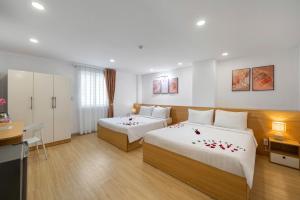 Postel nebo postele na pokoji v ubytování BIG Hotel Sài Gòn
