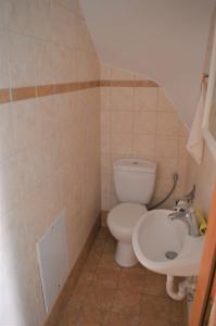 a bathroom with a toilet and a sink at Effie's Vacation House in Kanali