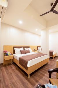 a bedroom with a large bed in a room at Airport Hotel Tashree Near Yashobhoomi - Free Airport Drop in New Delhi