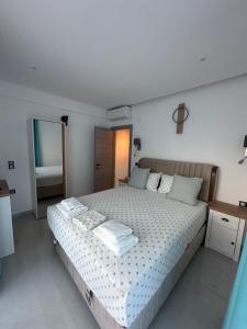 a bedroom with a bed with two towels on it at Danielli Luxury Villas in Skala Rachoniou