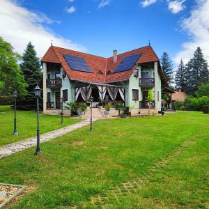 a house with a roof with solar panels on it at Balaton Garden in Balatongyörök