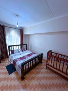 a bedroom with a wooden bed and a window at Lakeside Two Bedroom Penthouses in Goat Island