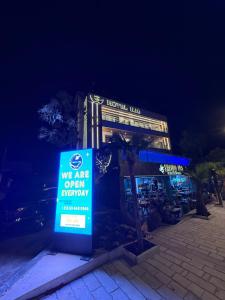 a sign in front of a restaurant at night at Ilio Boutique Hotel in Ksamil