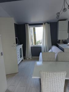 a bedroom with a white bed and a window at Camping DEL MAR in Argelès-sur-Mer