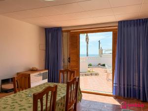 a dining room with a table and a view of a patio at Tossalet 37 in Oropesa del Mar
