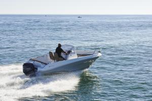 a man on a boat in the water at barca maria in Ladispoli