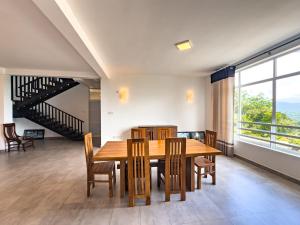 a dining room with a wooden table and chairs at Red Chillies Nature Inn in Kandy