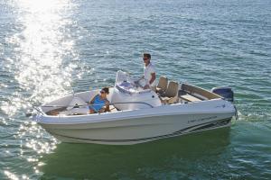 a man and a woman in a boat on the water at barca maria in Ladispoli