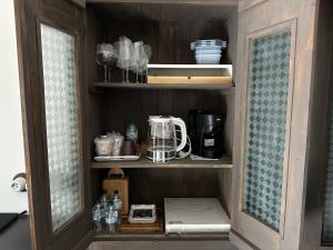 a cupboard with a blender and other items in it at Сasa Del Signore I in Baveno