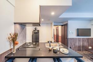 a kitchen with a sink and a stove at Apartment Hotel 11 Abeno in Osaka
