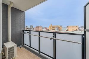 a balcony with a view of a city at Apartment Hotel 11 Abeno in Osaka +59 photos
