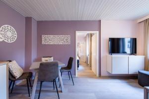 a living room with a table and a tv at Ignaz 28 Apartment#5 in Salzburg