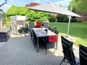 a table and chairs with an umbrella on a patio at Landhaus Scholz in Dollerup