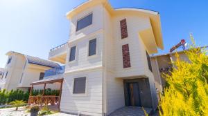 a white house with aventh floor at SUNSHINE VILLALAR in Belek