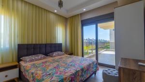 a bedroom with a bed and a large window at SUNSHINE VILLALAR in Belek +8 photos