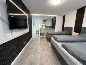 a bedroom with two beds and a flat screen tv at Apartments in Nürnberg