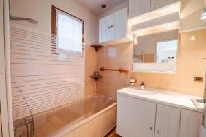 a bathroom with a tub and a sink and a shower at Le Mazet des Criques Charm and Beach 2 Steps Away in Cavalaire-sur-Mer +12 photos