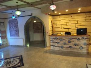 a room with a stone wall and a counter in a building at Waha Hotel in Bursa