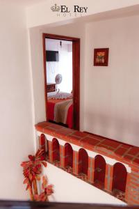 a bedroom with a mirror and a bed in it at El Rey in Taxco de Alarcón
