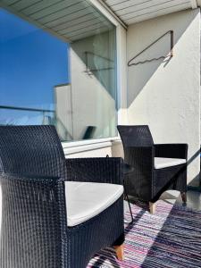 a patio with two chairs and a table and a window at Borg Itsenäisyydenkatu, Centre Spacious 2-Room Apt, King Bed, Free Parking & Wifi in Pori