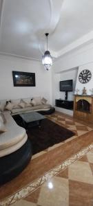 a living room with a couch and a table at Villa Fatima in Meknès