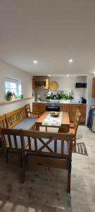 a kitchen with a table and chairs in a room at Ferienwohnung Am Dächsberg in Plauen +9 photos
