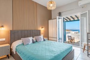 a bedroom with a bed with a view of the ocean at Porto Galini Tinos Myrsini 106 in Agios Ioannis Tinos