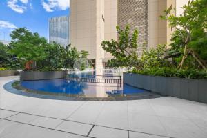 a swimming pool in the middle of a building at Sivora by Kozystay - Kuningan in Jakarta