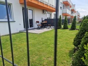 a view of a yard with a table and chairs at Apartamenty Krakowska 24 z ogródkiem in Ostrów Wielkopolski
