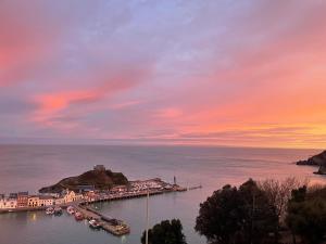 a harbor with boats in the water at sunset at Harbour View in Ilfracombe