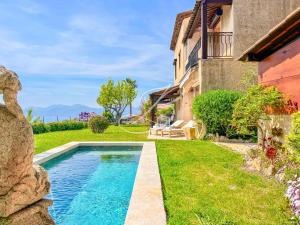 a swimming pool in a yard next to a house at Villa Blue Horizon - Panoramic Pools Cannes in Cannes +52 photos