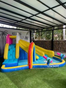 a inflatable water park with a slide in the grass at Keluang Hillside Villa Besut, Terengganu in Kampung Raja