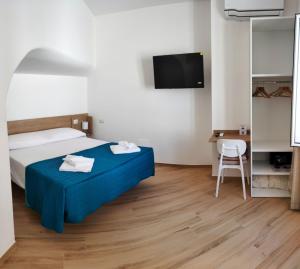 a hotel room with a bed and a television at La Parata in Ponza