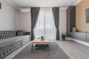a living room with a couch and a table at FELIX LOTUS - DeLuxe Residence in Baile Felix +24 photos
