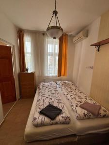 a bedroom with a large bed in a room at Centrum Vendégház in Debrecen