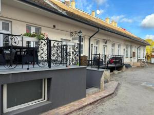 a building with a balcony with a table on it at Centrum Vendégház in Debrecen