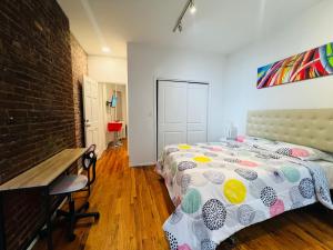 a bedroom with a bed and a brick wall at Fifty West New York in New York